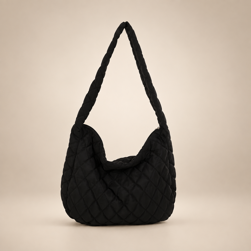 Quilted crossbody bag on a warm ivory studio background