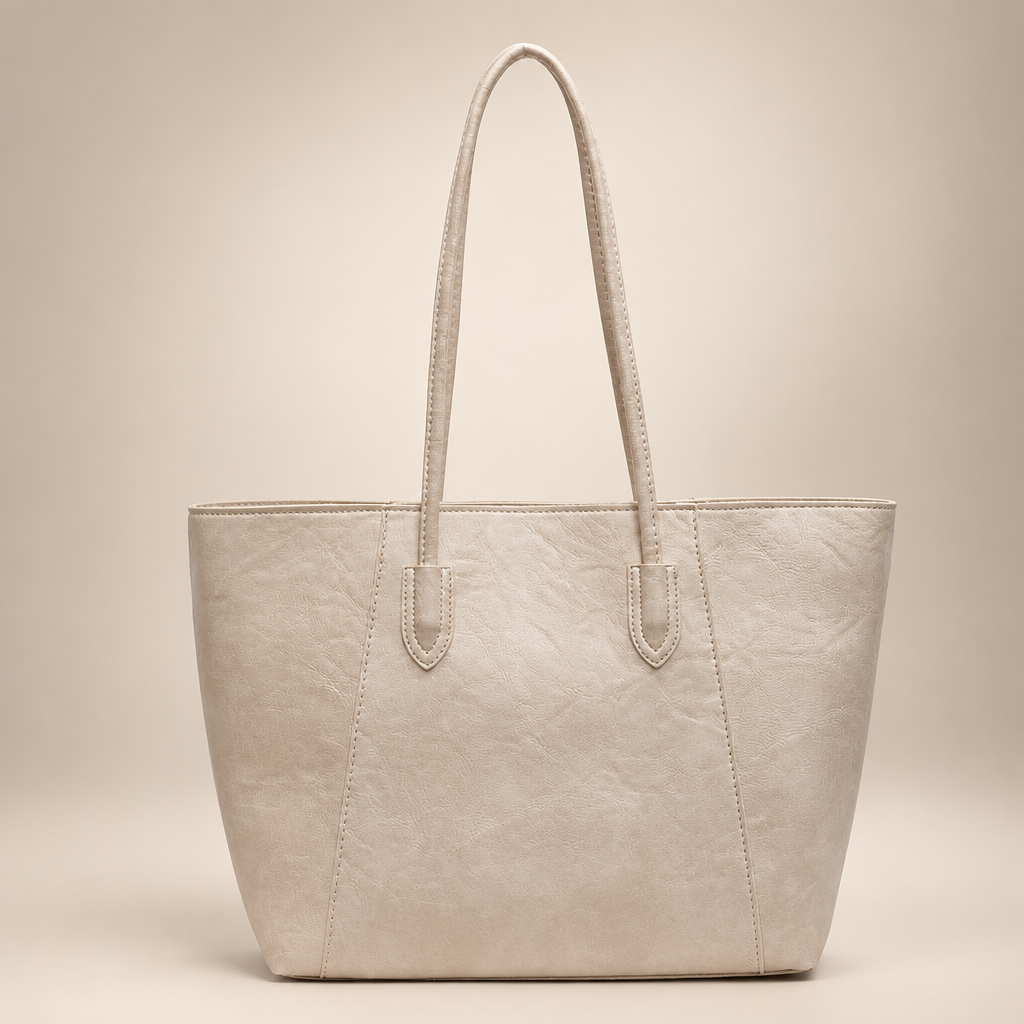 Brown PU tote bag photographed on a warm ivory studio background