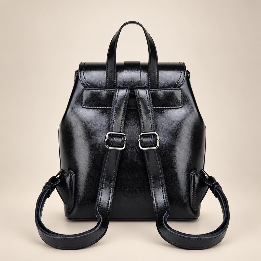 Leather backpack on warm ivory studio background