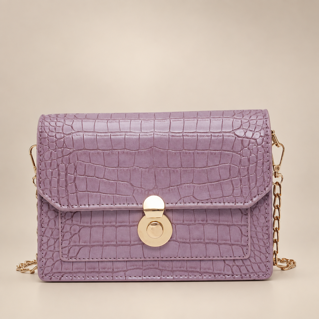 Lilac croc-embossed chain bag on a warm ivory studio background