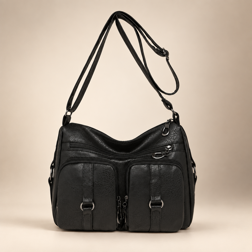 Alternate black PU crossbody bag image with adjustable strap on a warm ivory studio background