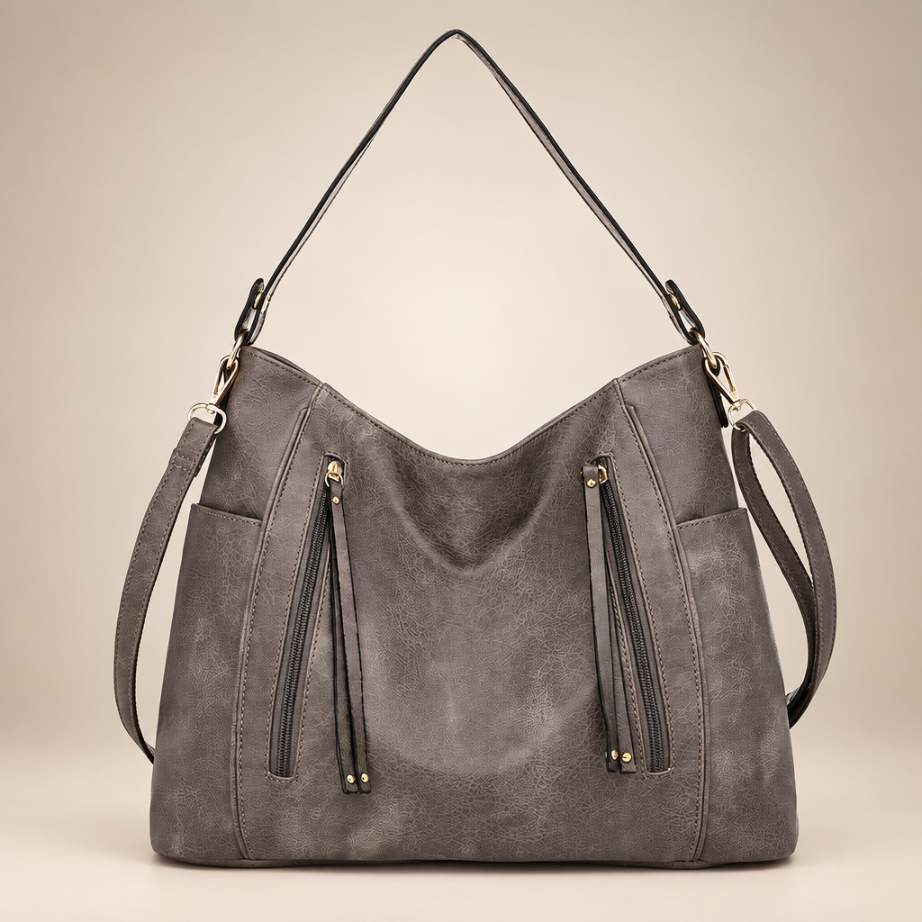 Women's slouchy hobo shoulder bag in grey on a warm ivory/taupe studio background