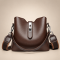 Brown bucket bag with silver hardware on a warm ivory studio background