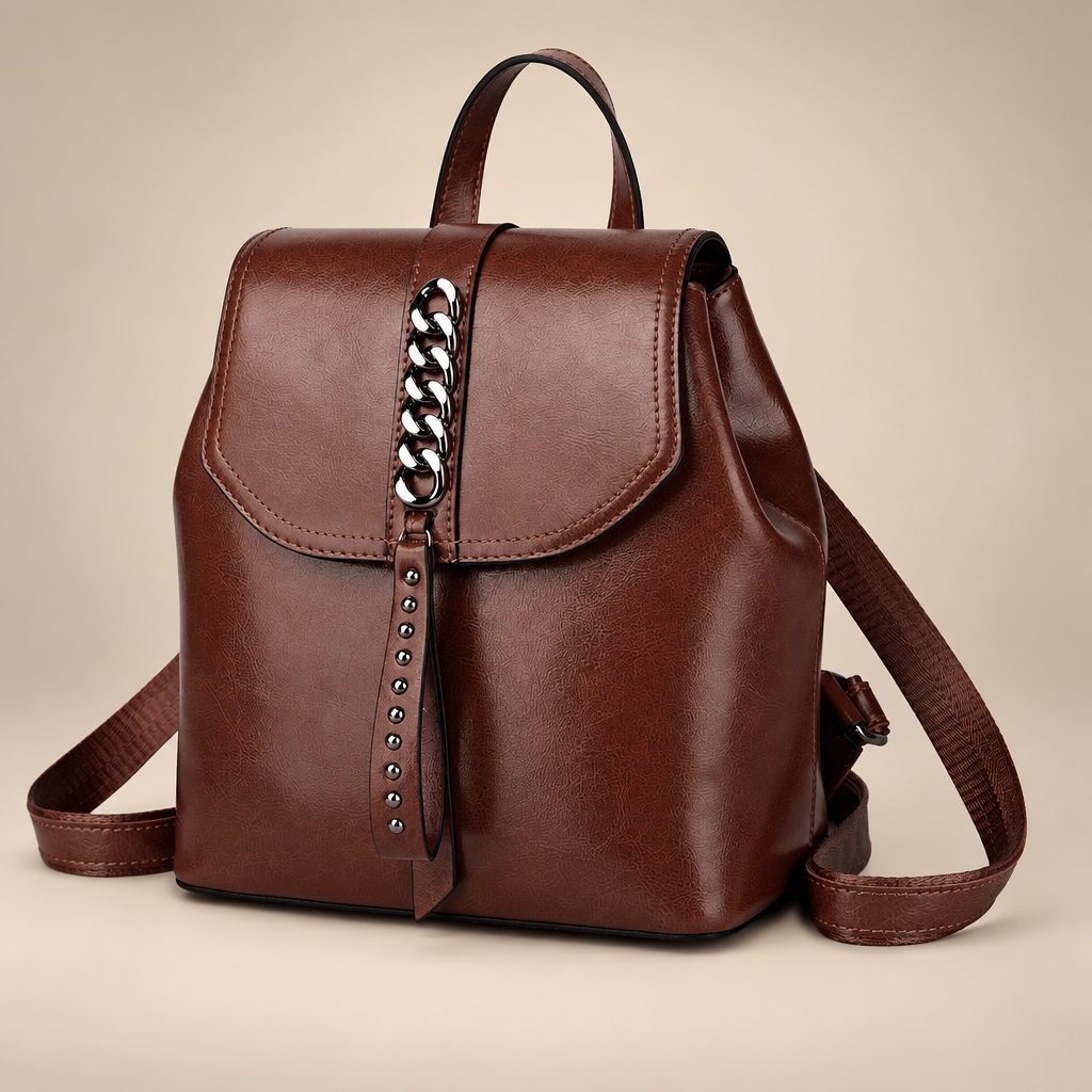 Leather backpack on warm ivory studio background