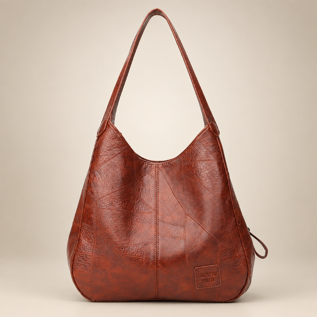 Vintage women's shoulder bag in chestnut brown on a warm ivory/taupe studio background