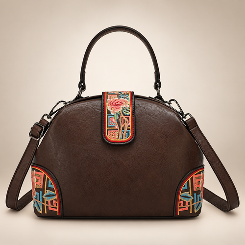 Dark brown dome handbag with colourful floral panels on an ivory studio background