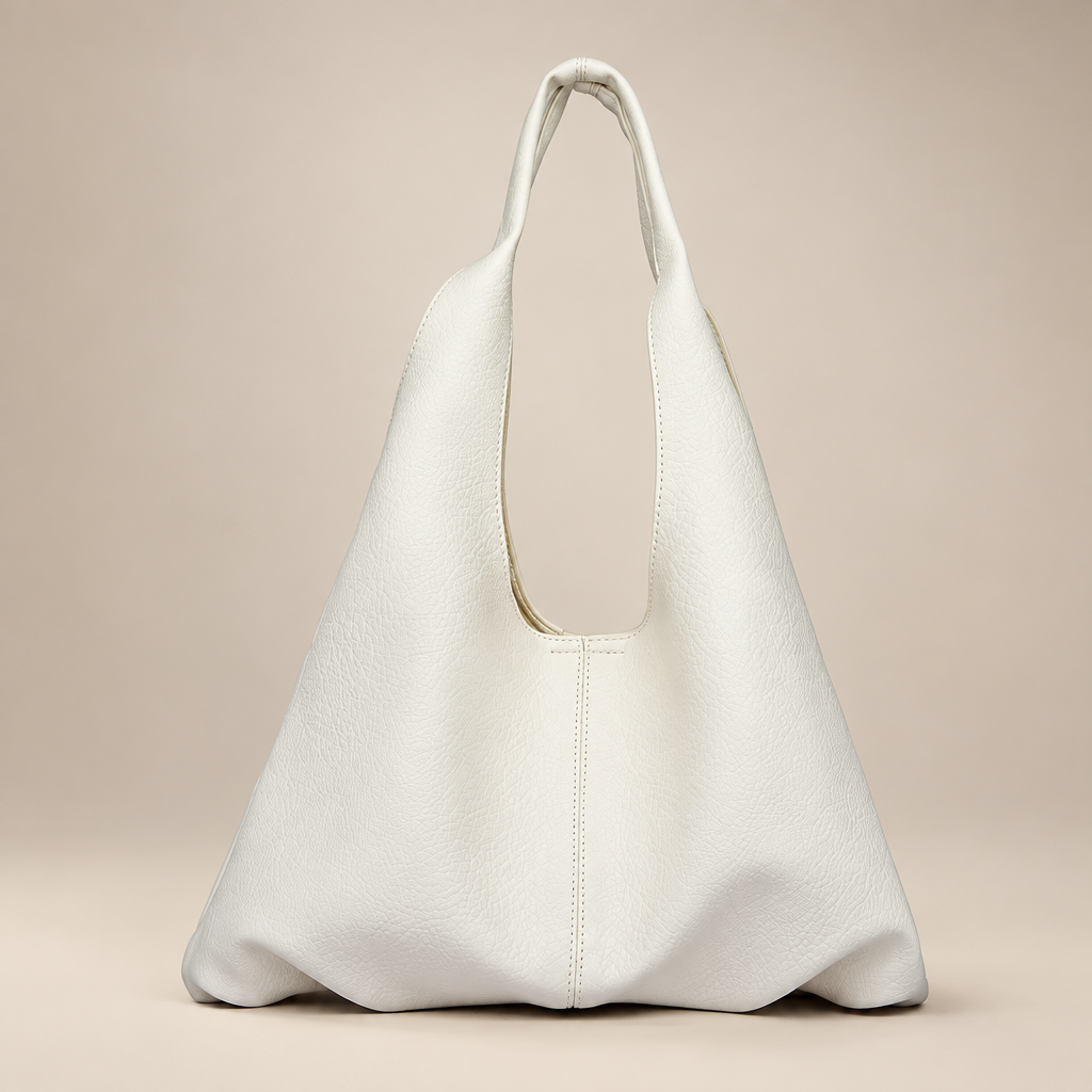 Women's slouchy shoulder tote in white on a warm ivory/taupe studio background