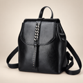 Leather backpack on warm ivory studio background
