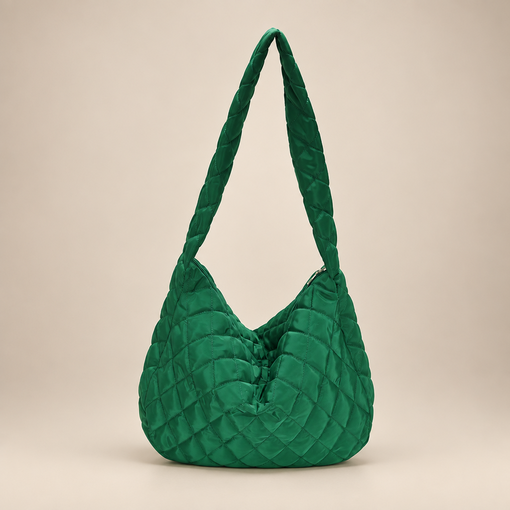 Quilted crossbody bag on a warm ivory studio background