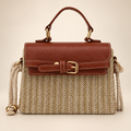 Brown woven box rattan handbag on warm ivory studio background