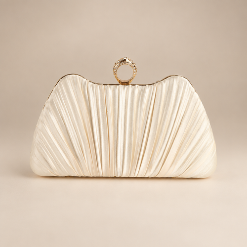 Champagne satin evening clutch with pleated front and jewelled ring clasp on a warm ivory studio background