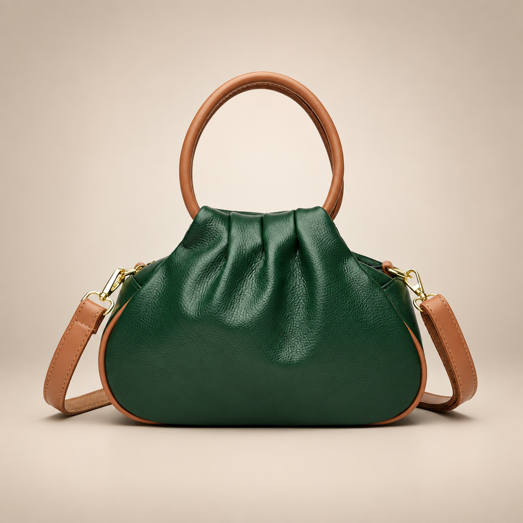 Green pleated bag with tan round handles on a warm ivory studio background