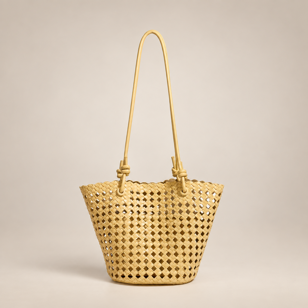 Tan open-weave bucket bag on an ivory studio background