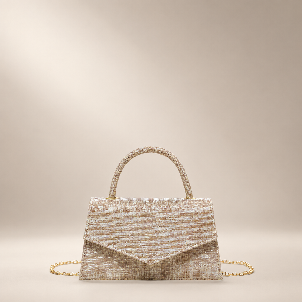 Gold small square PU handbag with a top handle and chain strap on a warm ivory studio background