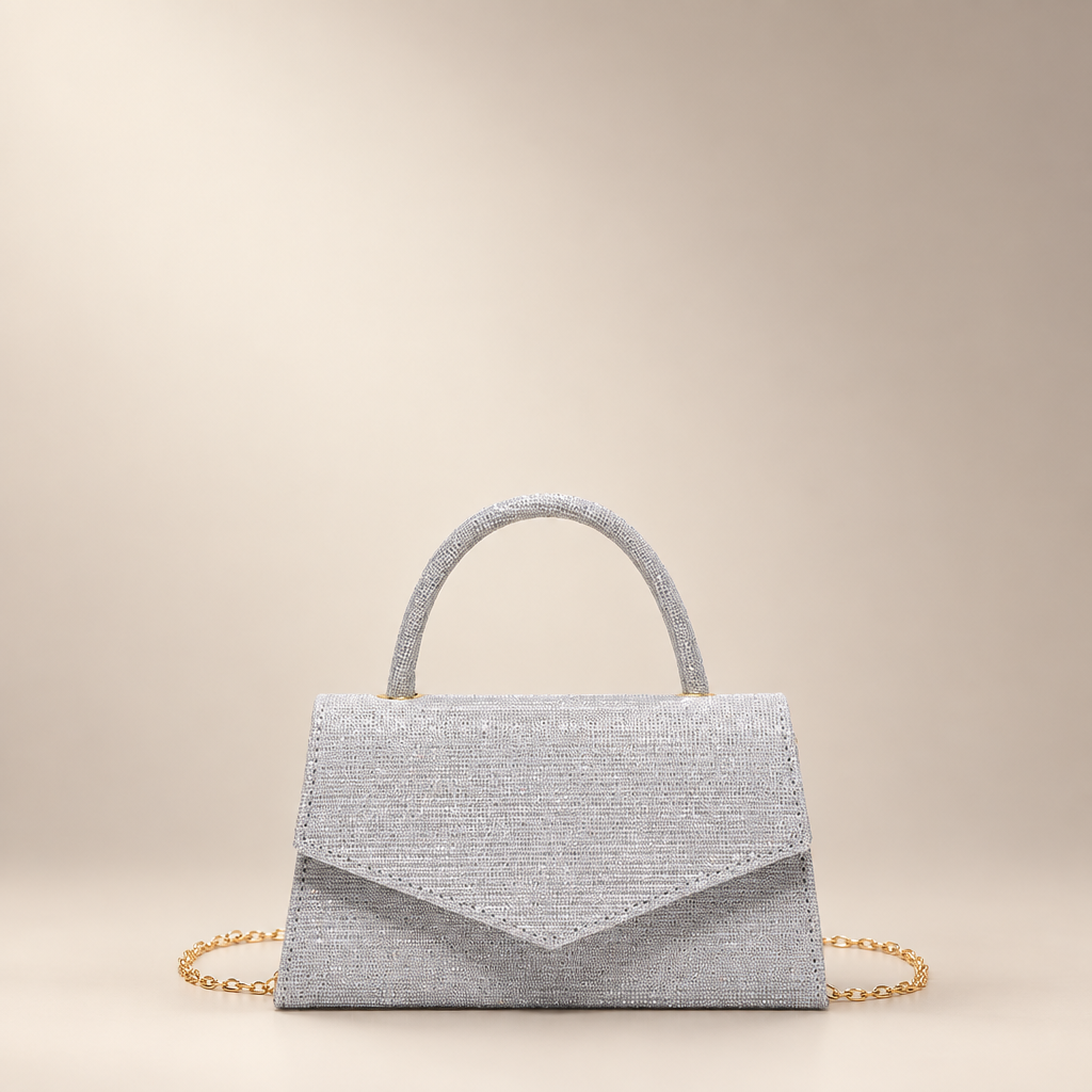 Silver small square PU handbag with a top handle and chain strap on a warm ivory studio background