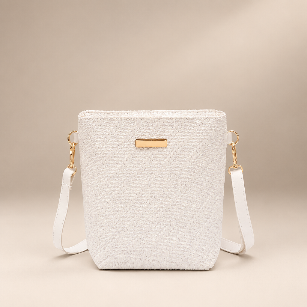 White PU shoulder bag with embossed texture against a warm ivory and taupe studio background