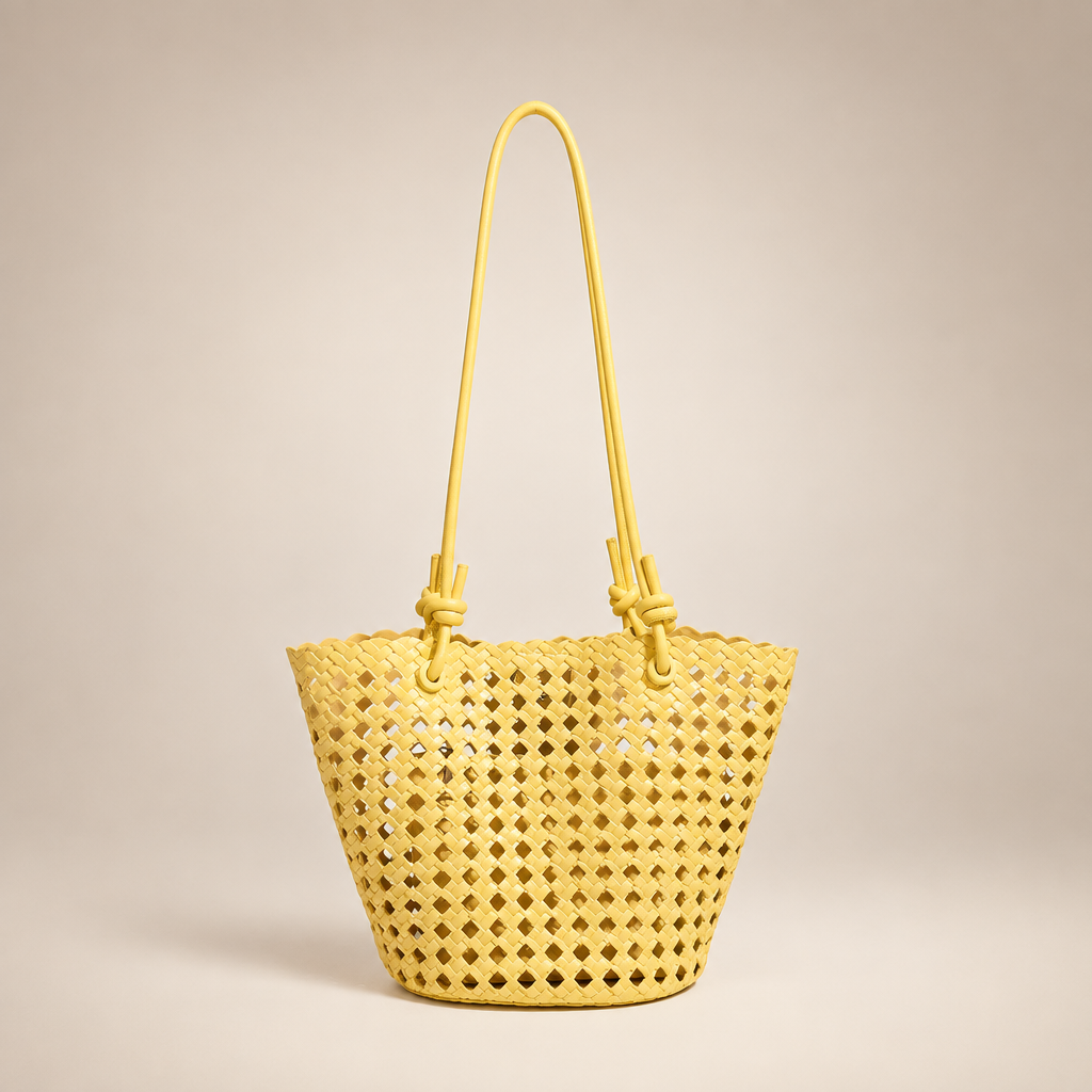 Yellow open-weave bucket bag on an ivory studio background