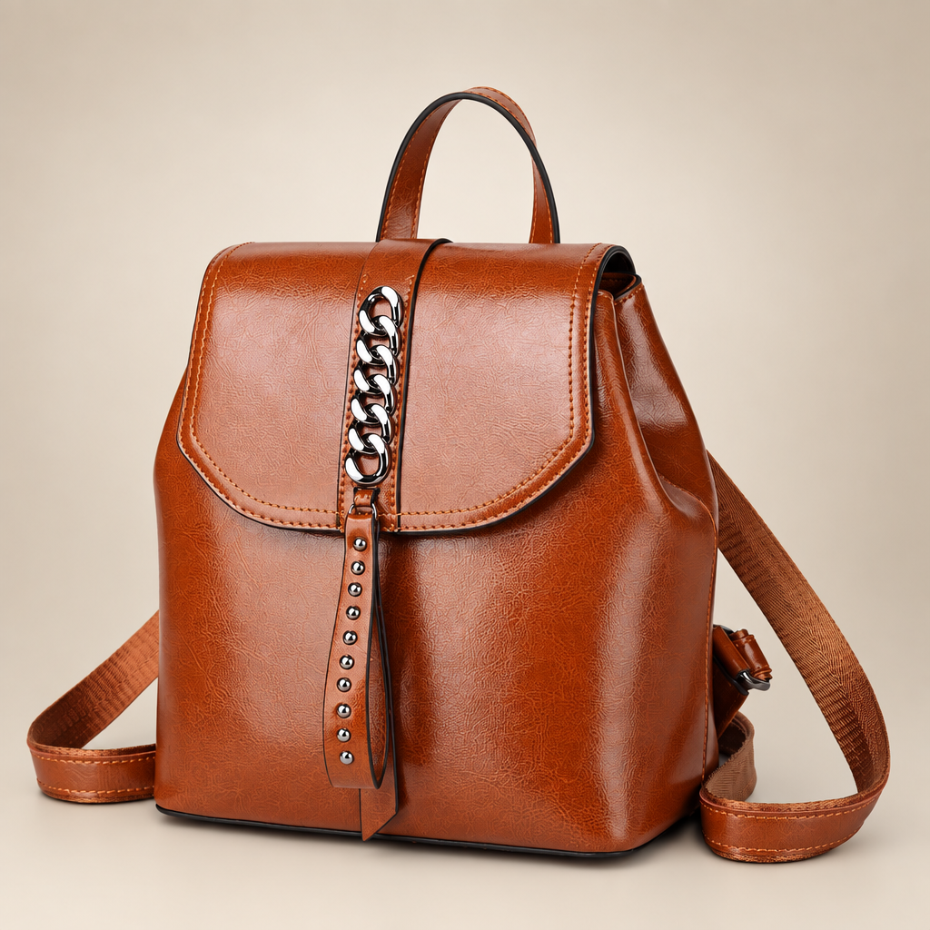 Leather backpack on warm ivory studio background