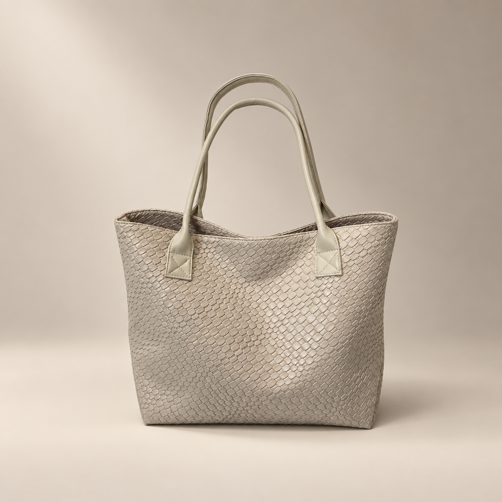 Beige woven PU shoulder bag with double straps on a warm ivory and taupe studio background