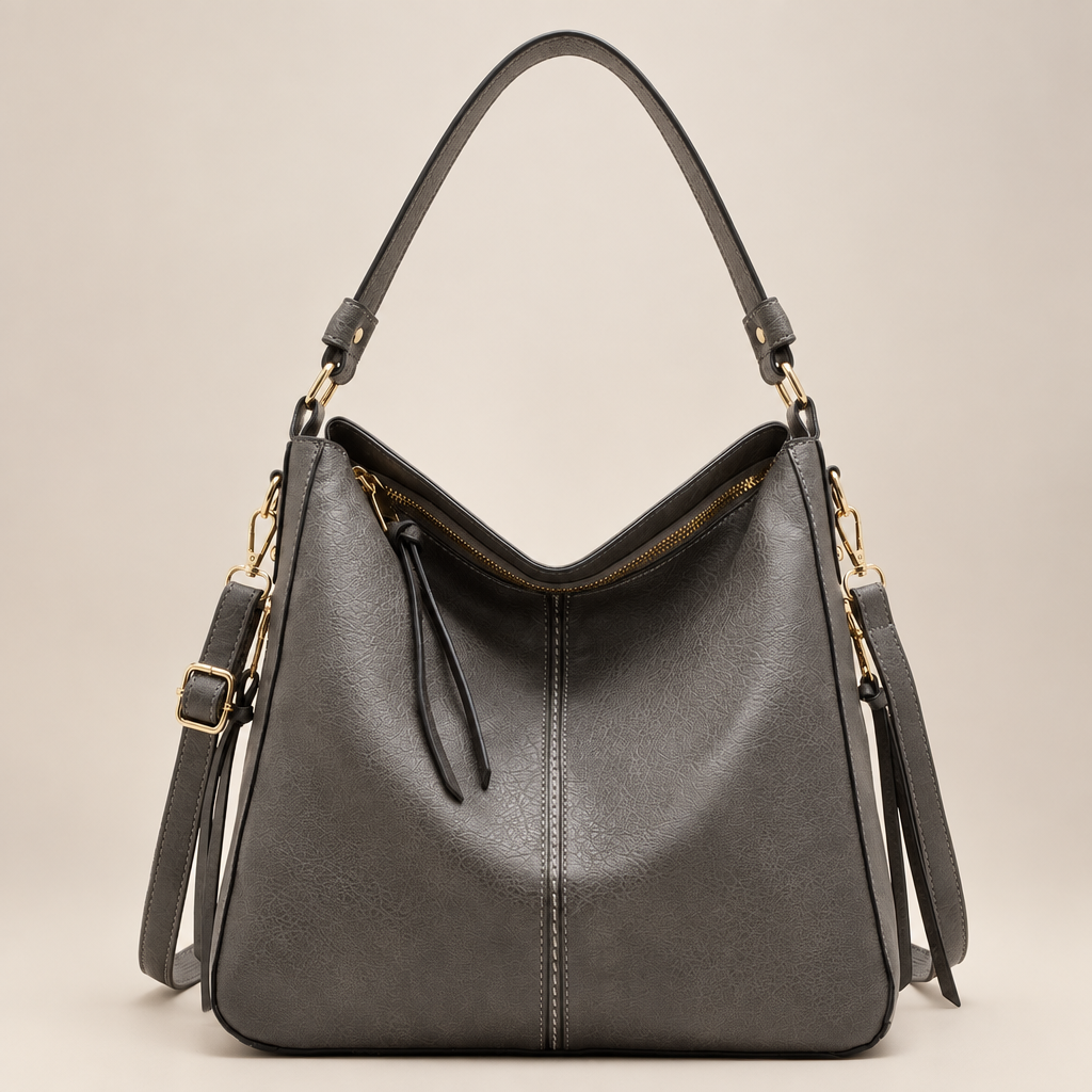 Light grey hobo shoulder bag on warm ivory studio background
