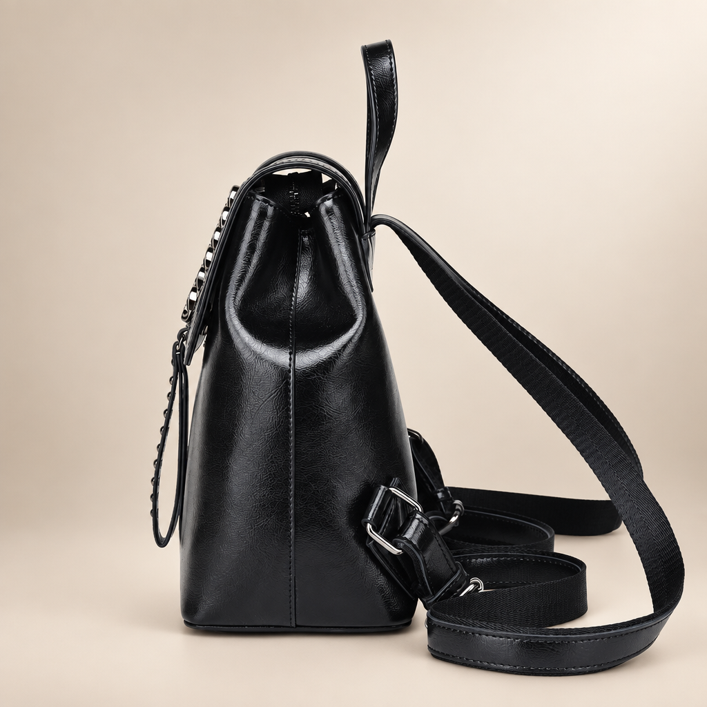 Leather backpack on warm ivory studio background