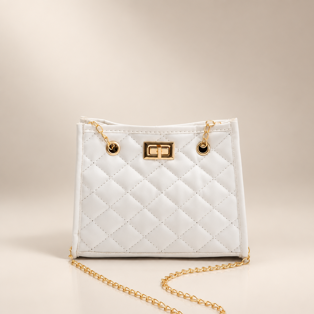 White quilted mini chain shoulder bag on a warm ivory/taupe studio background