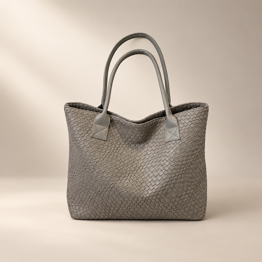 Gray woven PU shoulder bag with double straps on a warm ivory and taupe studio background