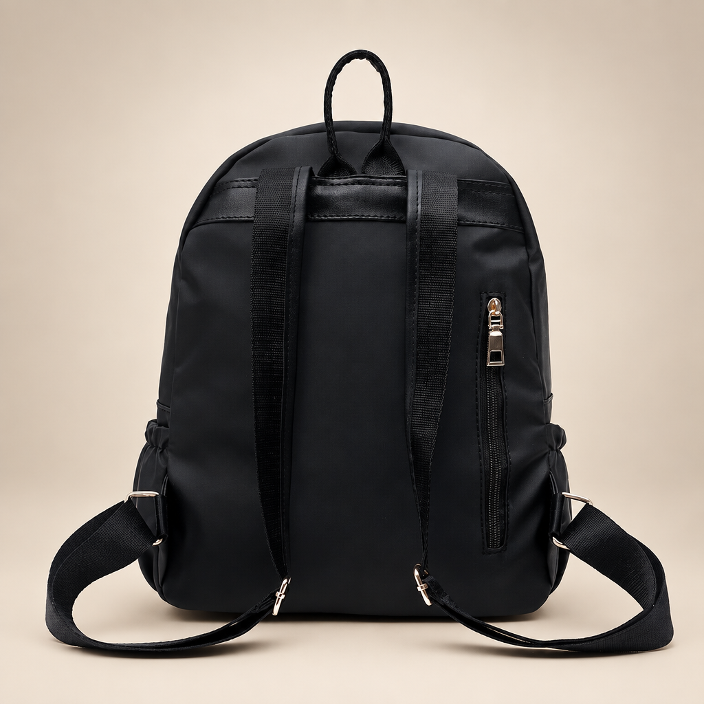 Black waterproof school backpack, back view, on a warm ivory/taupe studio background
