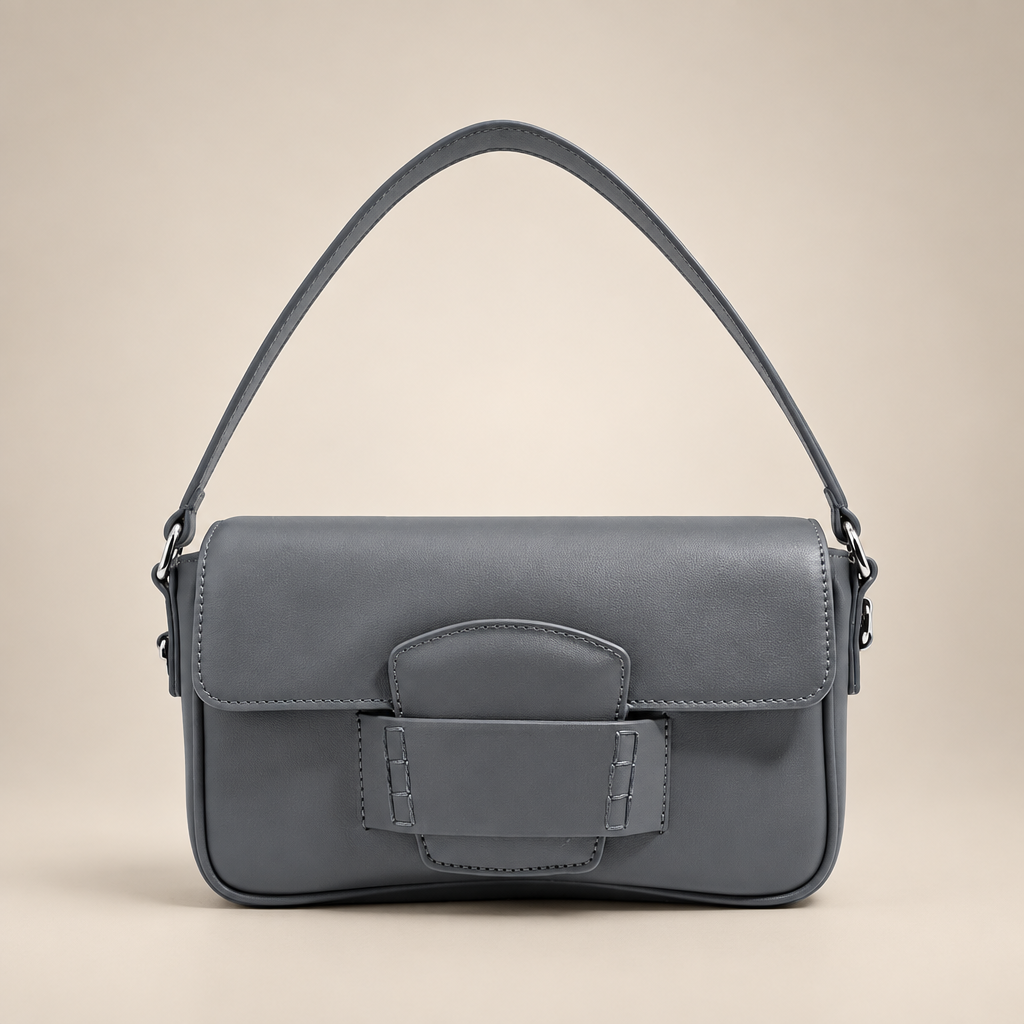 Grey flap shoulder bag on a warm ivory studio background