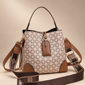Plaid handbag photographed on a warm ivory studio background