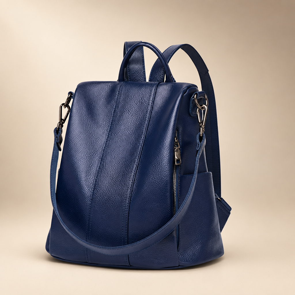 Sapphire blue genuine leather backpack against a warm ivory and taupe studio background