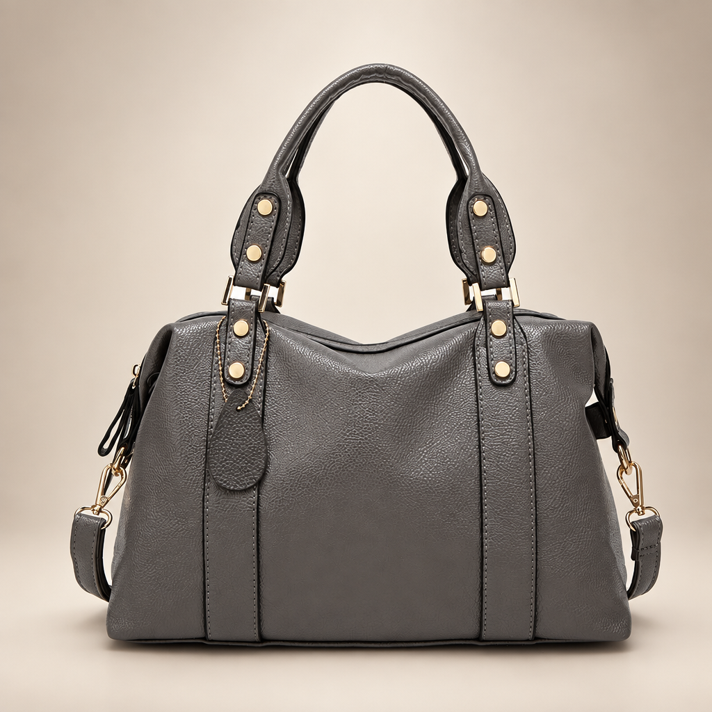 Grey handbag on a warm ivory studio background