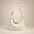 Ivory woven shoulder bag on a warm ivory studio background