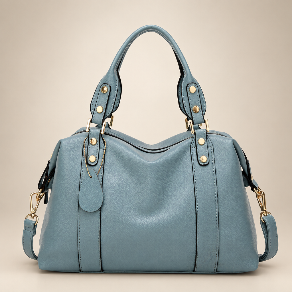 Blue handbag on a warm ivory studio background