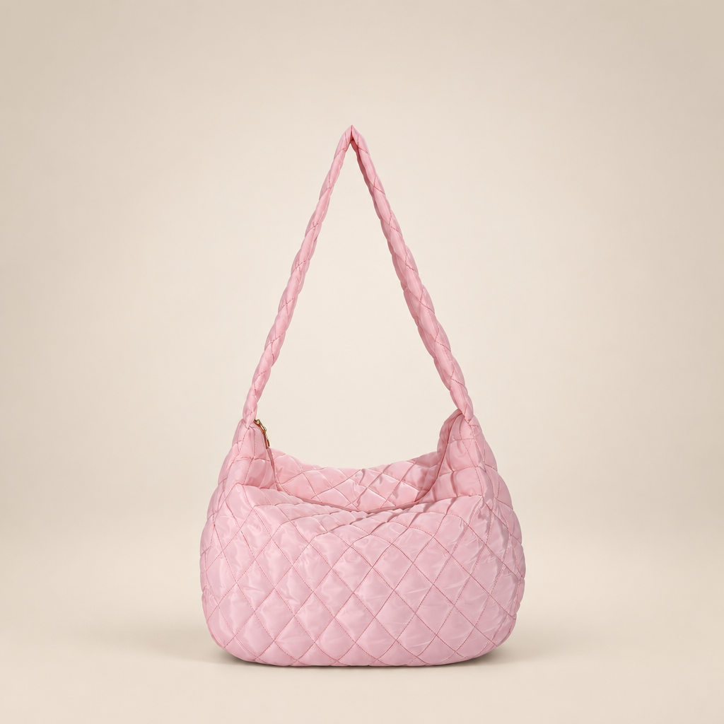 Quilted crossbody bag on a warm ivory studio background