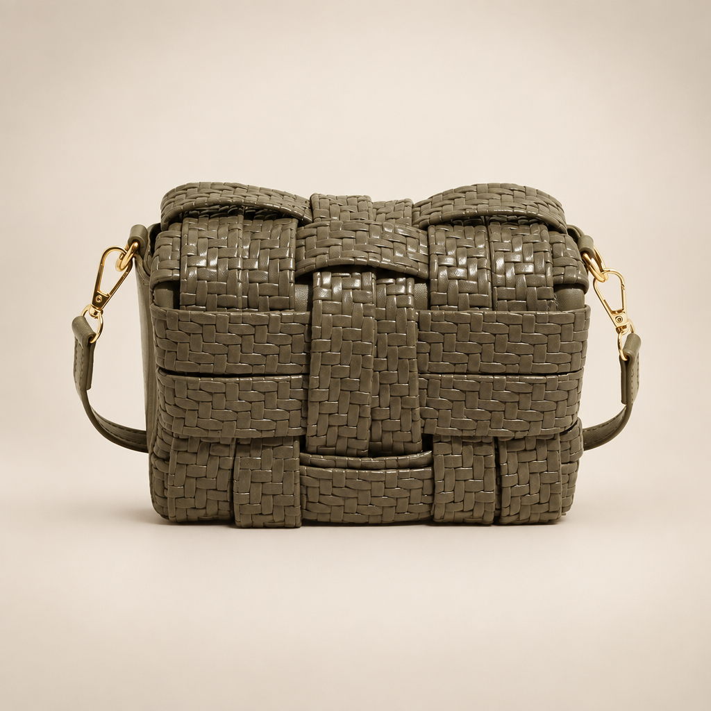 Olive-taupe woven crossbody bag on a warm ivory studio background
