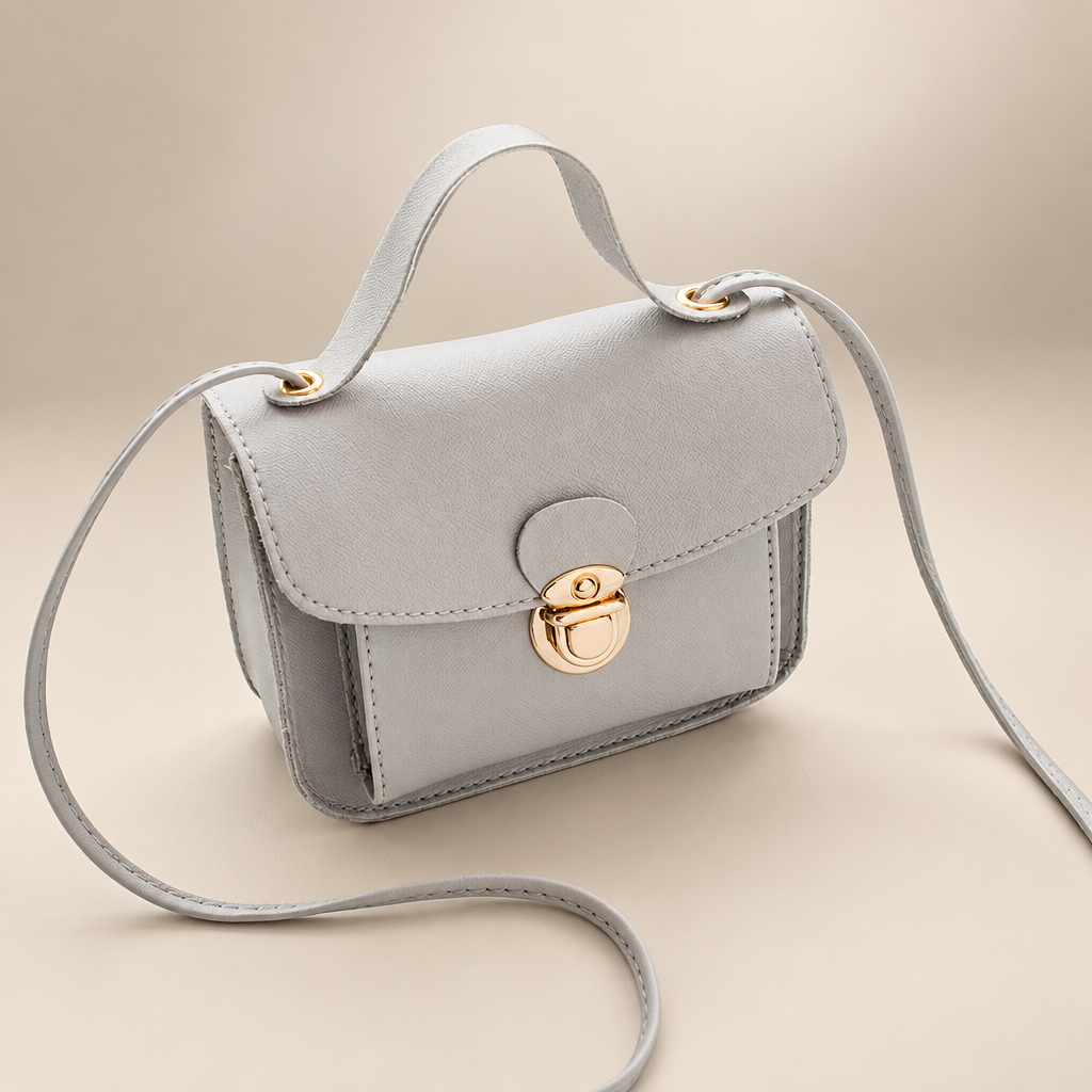 Women's envelope crossbody bag in grey on a warm ivory/taupe studio background