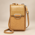 Chain-detail phone shoulder bag on a warm ivory and taupe studio background