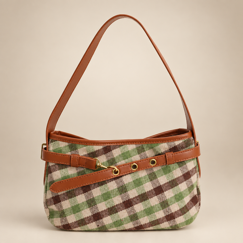 Green and cream plaid baguette bag with tan trim on a warm ivory studio background