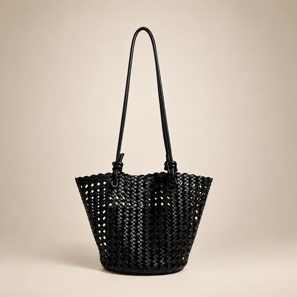 Black open-weave bucket bag on an ivory studio background